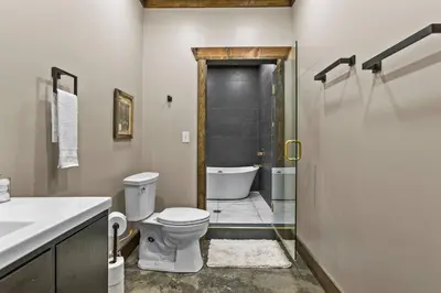 a bathroom with a toilet and a sink and a shower at Sleeps 24/ 4 Kitchens / 4 Hot Tubs / 4 Firepits in Stanton
