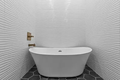 a white bath tub sitting in a bathroom at Sleeps 24/ 4 Kitchens / 4 Hot Tubs / 4 Firepits in Stanton