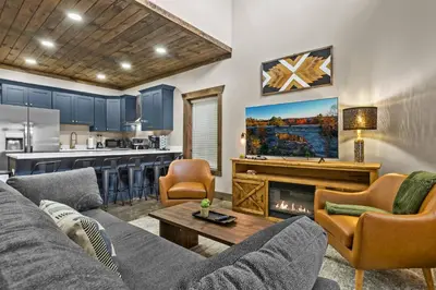 a living room with a couch and a fireplace at Sleeps 24/ 4 Kitchens / 4 Hot Tubs / 4 Firepits in Stanton