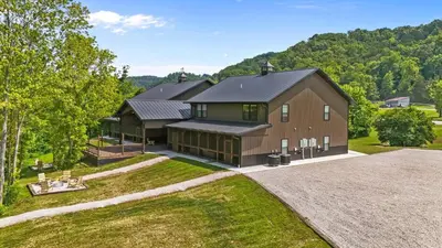 an aerial view of a large house with a driveway at New/12 Guest /2 Hot Tubs/ 2 Kitchens/ 2 Firepits in Stanton