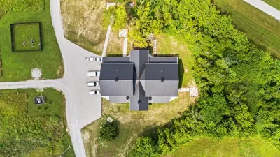 an aerial view of a house with a roof at New/12 Guest /2 Hot Tubs/ 2 Kitchens/ 2 Firepits in Stanton