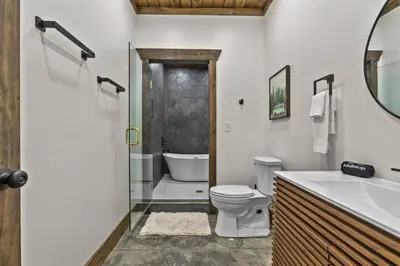 a bathroom with a toilet and a shower and a sink at New Barn/ Sleeps 12/ 2 Hot Tubs/ EV Charger in Stanton