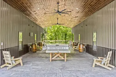 a ping pong table in the back of a building at New Barn/ Sleeps 12/ 2 Hot Tubs/ EV Charger in Stanton
