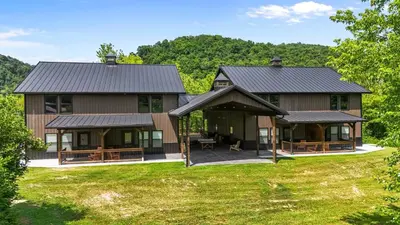 a large home with a gambrel roof at New Barn/ Sleeps 12/ 2 Hot Tubs/ EV Charger in Stanton