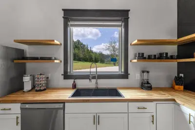 a kitchen with a sink and a window at New Barn/King Beds/Hot Tub/Spacious Level Parking in Stanton