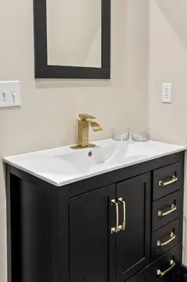 a bathroom vanity with a sink and a mirror at New Barn/King Beds/Hot Tub/Spacious Level Parking in Stanton
