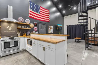 a kitchen with an american flag on the wall at New Barn/King Beds/Hot Tub/Spacious Level Parking in Stanton