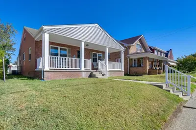 a home with a large lawn in front of it at Walk to Ritter Park Renovated Home Near Marshall! in Huntington