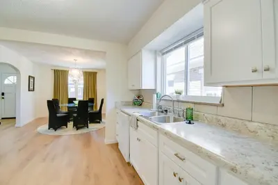 a kitchen with white cabinets and a dining room at Walk to Ritter Park Renovated Home Near Marshall! in Huntington