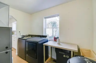 a kitchen with a black refrigerator and a table at Walk to Ritter Park Renovated Home Near Marshall! in Huntington