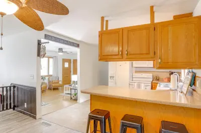 a kitchen with wooden cabinets and a counter top at Steps to Lake Erie! Cedar Point Home Base with Deck in Sandusky