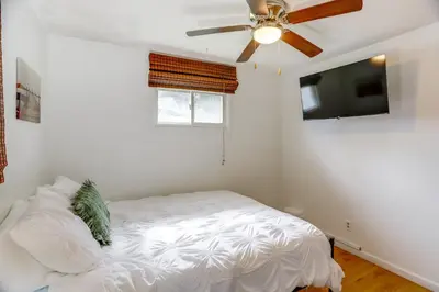 a bedroom with a bed and a ceiling fan at Steps to Lake Erie! Cedar Point Home Base with Deck in Sandusky