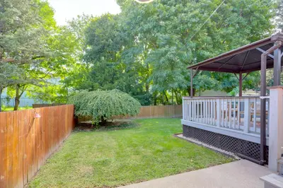 a backyard with a wooden fence and a gazebo at Steps to Lake Erie! Cedar Point Home Base with Deck in Sandusky