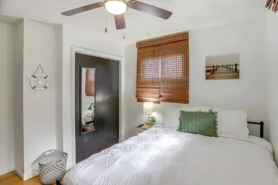 a bedroom with a white bed and a ceiling fan at Steps to Lake Erie! Cedar Point Home Base with Deck in Sandusky