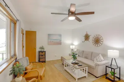 a living room with a couch and a ceiling fan at Steps to Lake Erie! Cedar Point Home Base with Deck in Sandusky