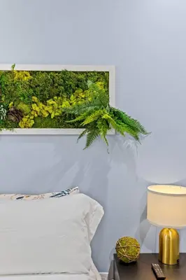 a picture hanging above a bed in a bedroom at Barndo/Ample Parking/Access to Red River/Hot Tub in Stanton