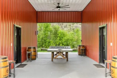 a barn with a ping pong table in the center at Barndo/Ample Parking/Access to Red River/Hot Tub in Stanton