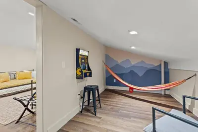 a room with a bed and a hammock in it at Barndo/Ample Parking/Access to Red River/Hot Tub in Stanton