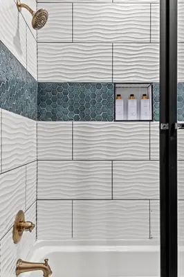 a bathroom with a shower with a tub and a sink at Barndo/Ample Parking/Access to Red River/Hot Tub in Stanton