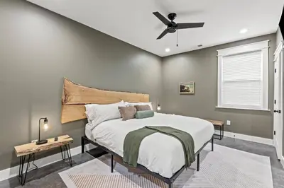 a bedroom with a bed and a ceiling fan at New Barndo/Red River Access/King Beds/Hot Tub in Stanton