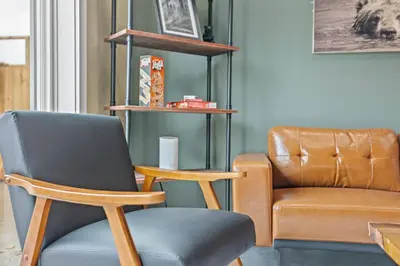 a living room with a chair and a couch at New Barndo/Red River Access/King Beds/Hot Tub in Stanton