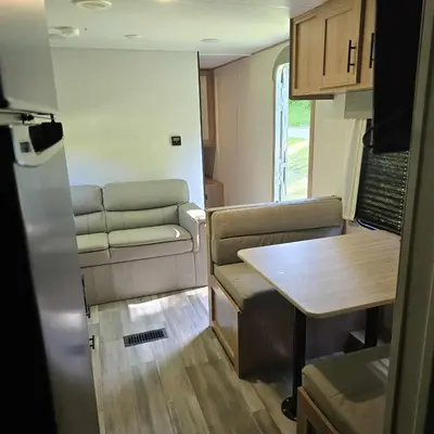 a small room with a table and a couch at Monday creek camper in New Straitsville