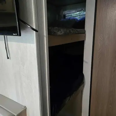 a door of a refrigerator with a bed in it at Monday creek camper in New Straitsville