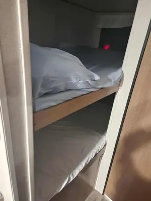 a bunk bed with a pillow on top of it at Monday creek camper in New Straitsville