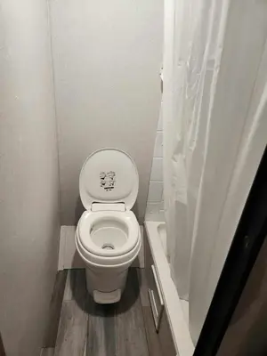 a small bathroom with a toilet and a shower at Monday creek camper in New Straitsville