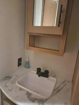 a bathroom counter with a sink and a mirror at Monday creek camper in New Straitsville
