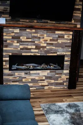 a brick fireplace with a tv on top of it at Little house on the prairie