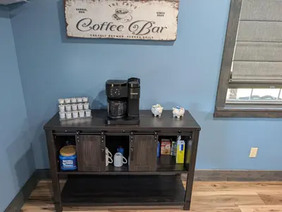 a coffee cart with a coffee maker on it at Little house on the prairie