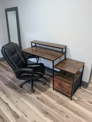 a desk and a chair in a room with a table at Little house on the prairie