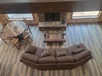 an overhead view of a living room with a couch and a table at WildWood Cabin in Gambier