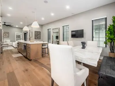 a kitchen and living room with a table and chairs at New Build OSU Short North Dtown in Columbus