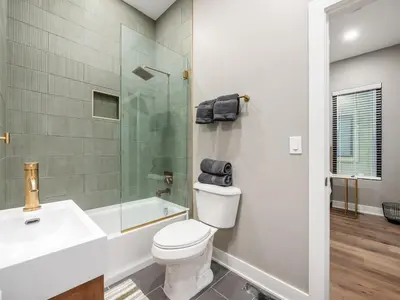 a bathroom with a toilet and a sink and a shower at New Build OSU Short North Dtown in Columbus