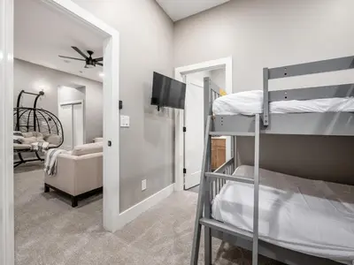 a bedroom with two bunk beds and a living room at New Build OSU Short North Dtown in Columbus