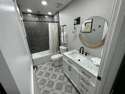 a bathroom with a sink and a toilet and a mirror at New Build, Downtown Views, next to NCH in Columbus