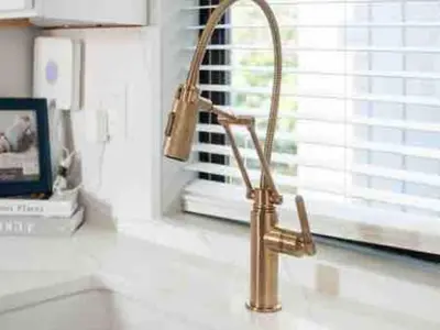 a gold faucet on a kitchen counter next to a window at Brand NEW Build, D-Town Views, must See in Columbus