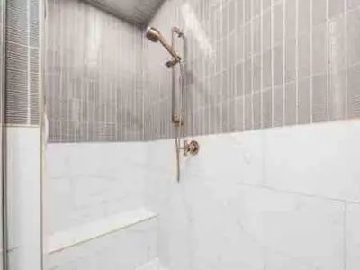 a shower with a glass door in a bathroom at Brand NEW Build, D-Town Views, must See in Columbus
