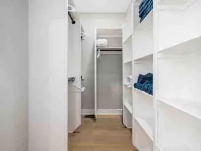 a bathroom with white walls and a hallway with a door at Brand NEW Build, D-Town Views, must See in Columbus