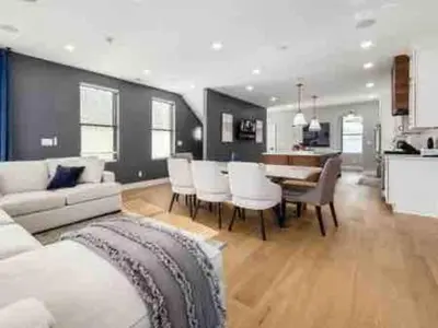 a living room with a couch and a table and chairs at Brand NEW Build, D-Town Views, must See in Columbus