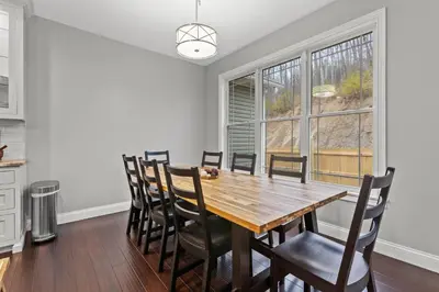 a dining room with a wooden table and chairs at Arch Fun Lodge - Game Room, Theater, HotTub & View in Stanton