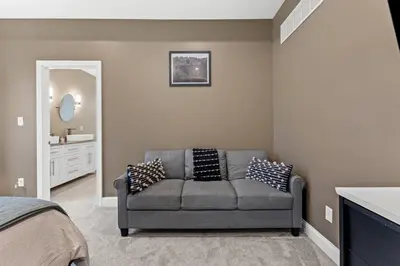 a living room with a couch and a bathroom at Arch Fun Lodge - Game Room, Theater, HotTub & View in Stanton