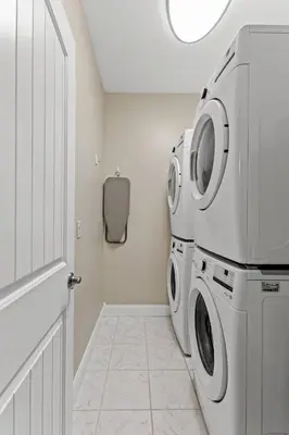 a white laundry room with a washer and dryer at Arch Fun Lodge - Game Room, Theater, HotTub & View in Stanton