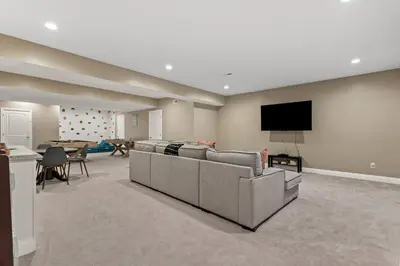 a living room with a couch and a flat screen tv at Arch Fun Lodge - Game Room, Theater, HotTub & View in Stanton