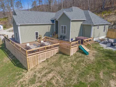 an aerial view of a house with a large deck at Arch Fun Lodge - Game Room, Theater, HotTub & View in Stanton