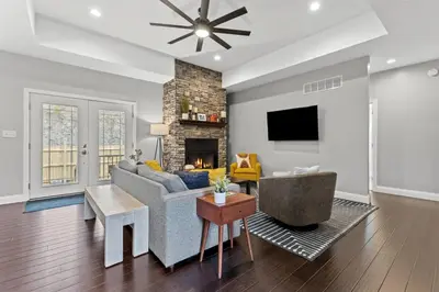 a living room with a couch and a fireplace at Arch Fun Lodge - Game Room, Theater, HotTub & View in Stanton