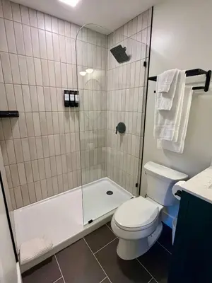 a bathroom with a toilet and a shower at The Produce Suites in Toledo