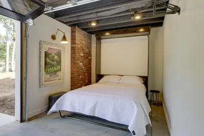 a bedroom with a bed in a brick wall at Unique Studio on Obanyon Creek in Dtwn Loveland! in Loveland